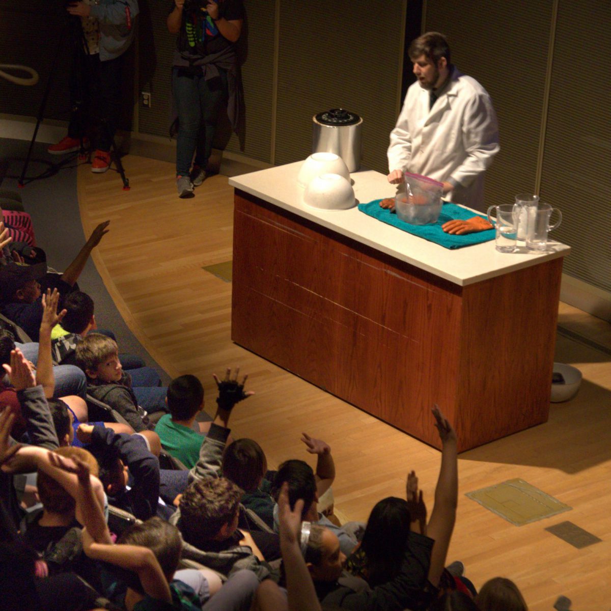 A crowd watches a live science demonstration at the Griffith Observatory.
