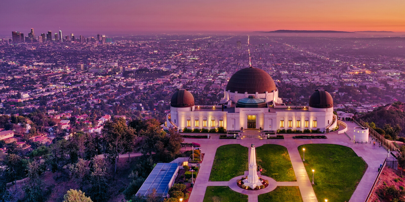 Overhead view of Griffith Observatory with Los Angeles in the background in the evening.